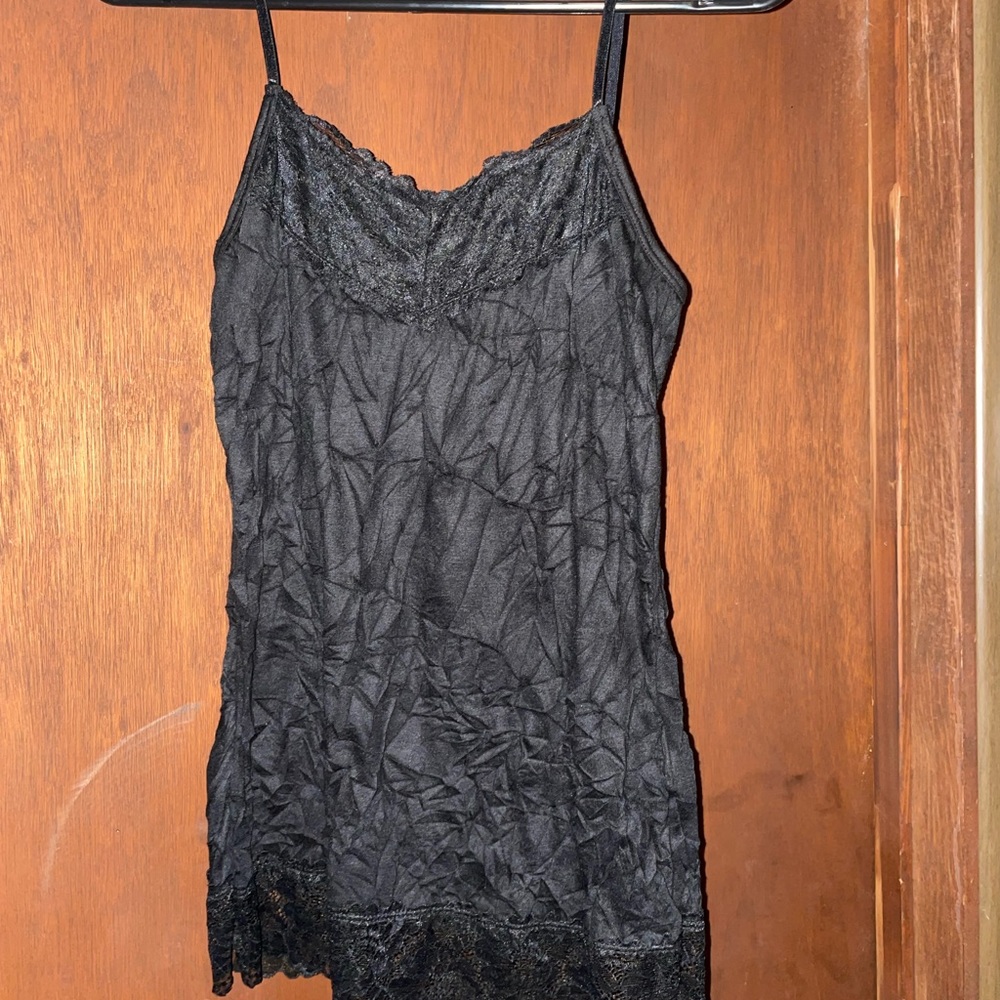 Cute, size small, black tank from Maurice’s. Wrinkles are part of the design.